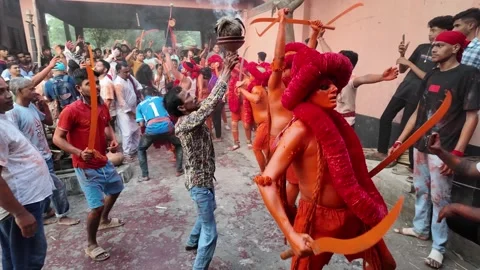 Devotees with swords in orange at Lal Kach festival, Munshiganj, Bangladesh Video stock 310757122