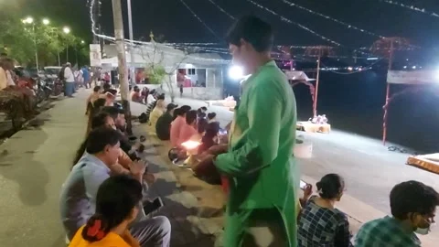 The devotees,  touching  the holy  light  prior to ganges worship. Stock Footage 173763507
