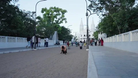Devotees Walking on Knees Toward Velankanni Basilica at Dusk Stockbeeldmateriaal 340036157