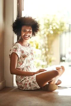 Devoting today to reading. Portrait of a young woman relaxing with a book at Stock Photos