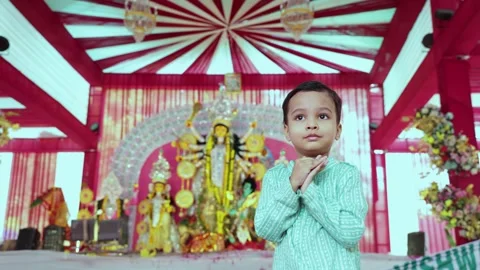Devotional Young Boy Offering Prayer at a Colorful Durga Puja Celebration Stock Footage 345287202
