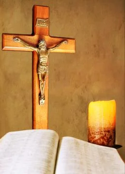 Devotions by candlelight with open Bible and crucifix Stock Photos
