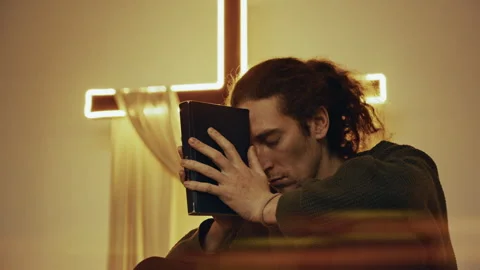 Devout christian man praying with holy bible in church Stock Footage 327207943