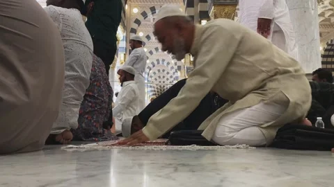 Devout men performing sujud during prayer inside Al-Masjid an-Nabawi Stock Footage 339763710