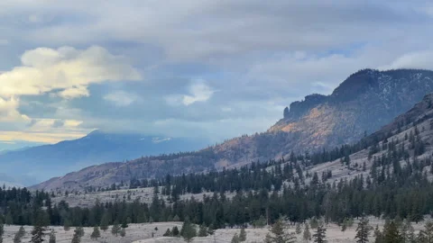 Dewdrop grasslands and Red Bluff cliffs near Kamloops B.C. storm clouds 4k.. Stock Footage 257613248