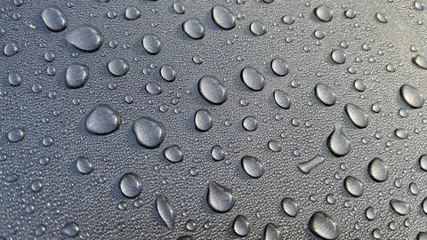 Dewdrops fall on the metal surface Stock Photos