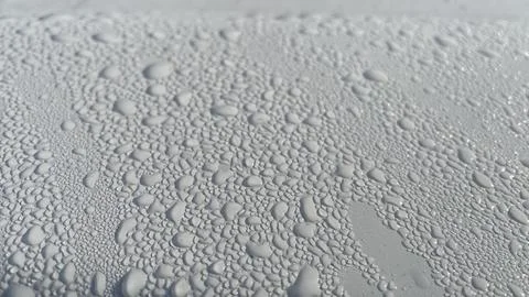 Dewdrops fall on the metal surface Stock Photos