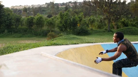 Dexterous young boy rollerblader jumping and falling on the ramp with two hands. Stock Footage 110904813