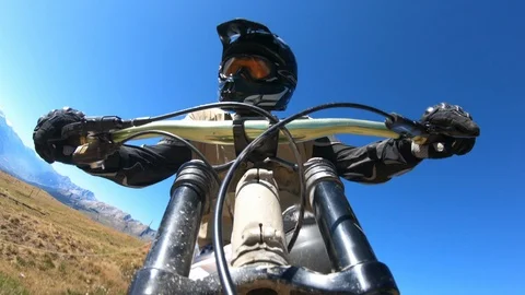 DH biker faces camera - Jump Stock Footage 117287143