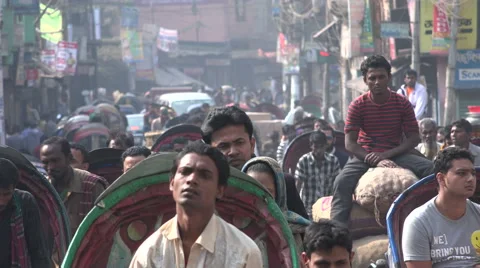 Dhaka, Bangladesh, cycle rickshaws ride through a busy street Stock Footage