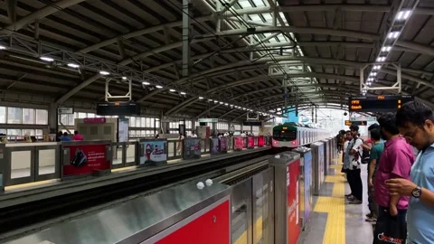 Dhaka Metro Rail train arriving at platform with waiting passengers Bangladesh Stock Footage 345667579