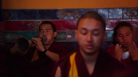 DHARAMSHALA, INDIA - 2020, OCT 13: Monk Playing Gyaling Horn at Prayer Service Stockbeeldmateriaal 345633217