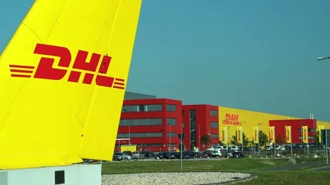 DHL Courier Sign to Sorting Facility Building Pan Stock Footage 86932301