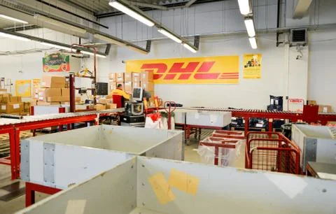 DHL delivery worker cheking package boxes Stock Photos