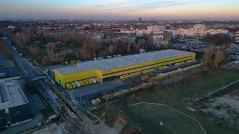 DHL Deutsche Post logistics center with delivery vans. Amazing aerial view drone Stock Footage 323256678