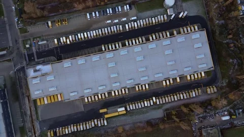 DHL Deutsche Post logistics center with delivery vans. Dramatic aerial view Stock Footage 323256695
