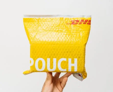 DHL Express yellow parcel plastic pouch Foto stock