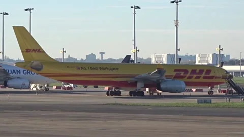 DHL Freight Cargo Parcel Delivery on time Airbus A330 cargo parked at airport Stock Footage 231604022