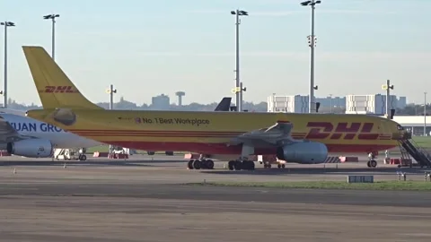 DHL Freight Cargo Parcel Delivery on time Airbus A330 cargo parked at airport Stock Footage 250082613