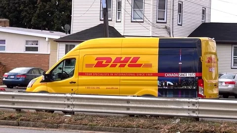 DHL package shipping mail delivery truck, zoom in Video stock 76523525
