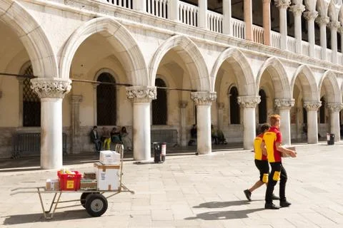 DHL Postmen delivering parcels on the Piazza San Marco in Venice Stock Photos