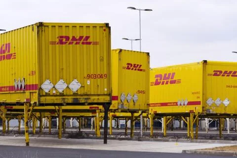 DHL shipping containers in front of Amazon logistics building 写真素材