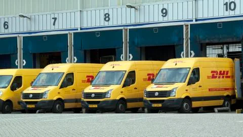 DHL vans befor a loading dock Stock Photos