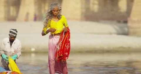 Dhobi Ghat (laundry by hand) using the Yamuna to wash traditional Indian Stock Footage 72985058