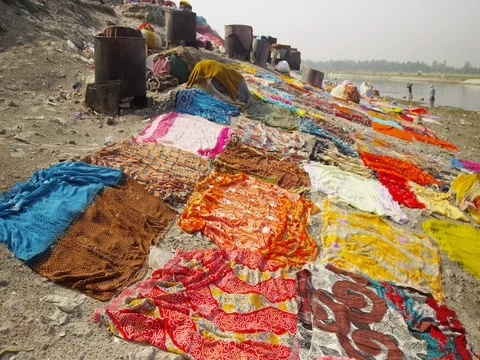 Dhobi Ghat (laundry by hand) using the Yamuna to wash traditional Indian Stock Footage 72990742