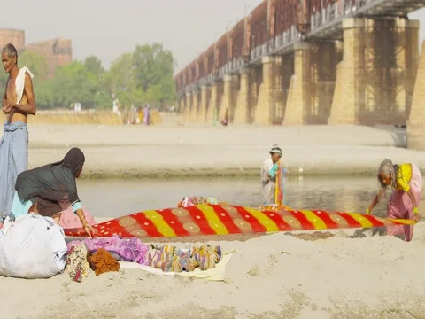 Dhobi Ghat (laundry by hand) using the Yamuna to wash traditional Indian Stock Footage 73001695