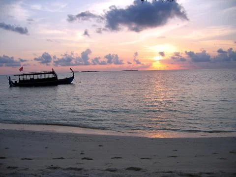 Dhoni in front of a romantic sunset Stock Photos