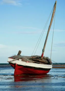 Dhow or traditional fishing sailing boat on it's side Stock Photos
