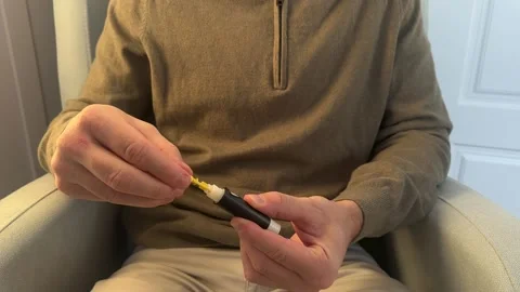 Diabetic man preparing lancet device for blood sugar test Stock Footage 324811705