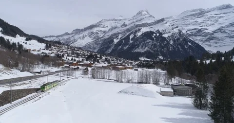 Diablerets train arrival in winter - Aerial 4K Stock Footage 104623202