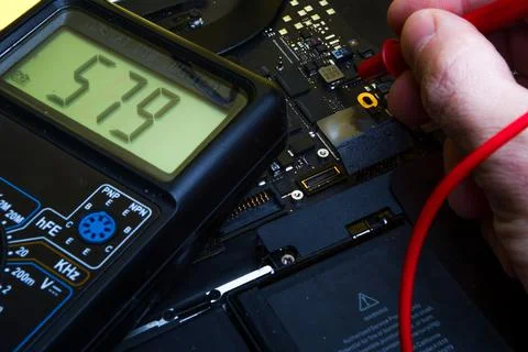 Diagnosing a computer motherboard with an electronic device Stock Photos