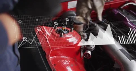 Diagnosing gloved tech in dark work shirt checking engine in garage, HUD showing Stock Photos