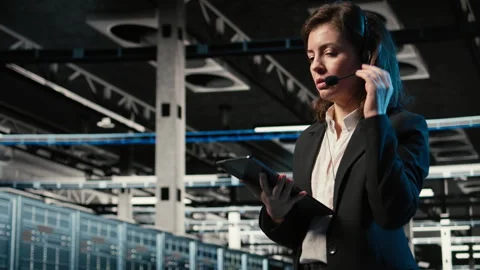 Diagnosing tech issues, AR holographic IT support worker in data center Stock Footage 328334720