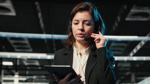 Diagnosing tech issues, AR holographic IT support worker in data center Stock Footage 329329817