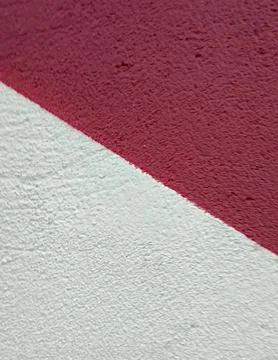 Diagonal abstract background of textured red and white painted wall surfaces Stock Photos