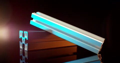 Diagonal aluminum profile bars resting on wooden block in moody light 動画素材 331442679