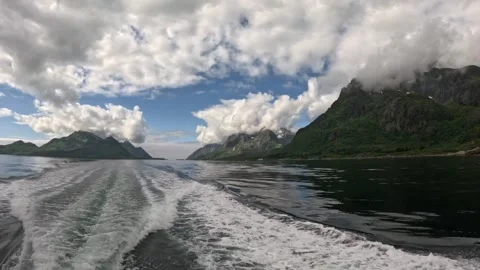 Diagonal boat wake from stern sailing through scenic mountain fjord in Lofoten Stock Footage 344753130