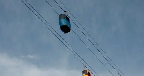 Diagonal cableway with cabins in the sky Stock Footage 108724245