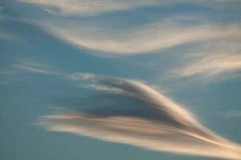 Diagonal clouds on blue sky Stock Photos