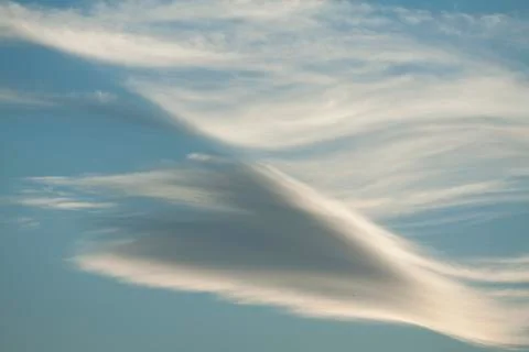 Diagonal clouds on blue sky Stock Photos