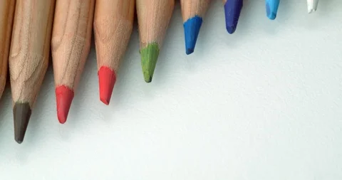 Diagonal colour pencils rolling onto top of frame Stock Footage 113142848