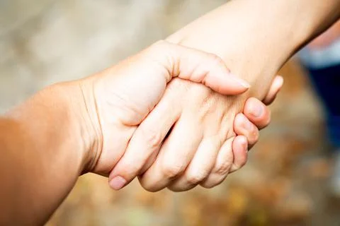 Diagonal composition. Two hands shaking outdoors. Team work and agreement Stock Photos