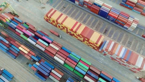 Diagonal container grid with moving freight trucks at Guangzhou Port Stock Footage 346446309
