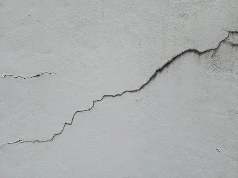 The diagonal cracks on the wall are of medium-level danger. Stock Photos