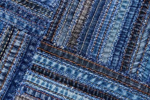 Diagonal denim fabric pattern in patchwork style. Stock Photos