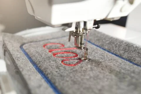 Diagonal detail view on a modern computerised sewing machine and embroidery u Stock Photos